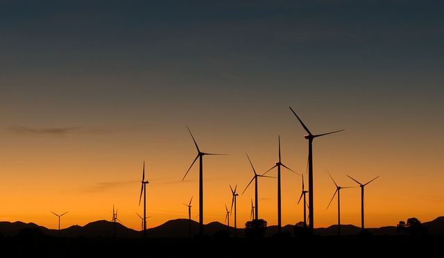 wind farm sunset Image by Markus Distelrath from Pixabay