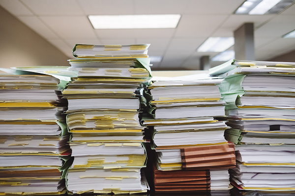 Bureaucracy rulemaking appaerwork red tape Photo by Wesley Tingey on Unsplash