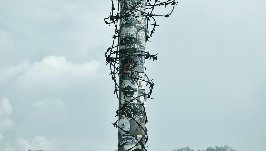 Pole barb wire original Photo by Duangphorn Wiriya on Unsplash