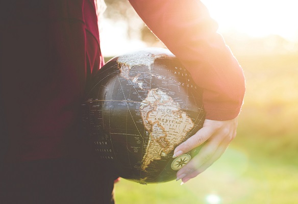 person holding a globe - the world Photo by Ben White on Unsplash