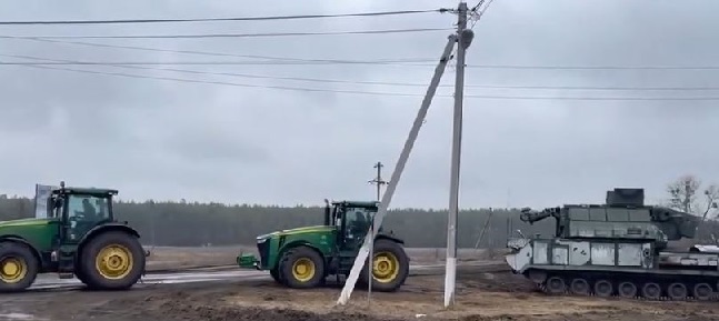 Ukrainian Farmer tractors towing Russian Military tank away