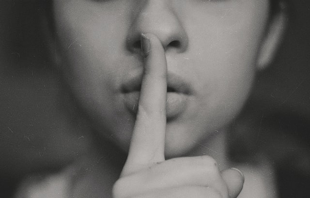 Secret finger on lips Photo by Kristina Flour on Unsplash