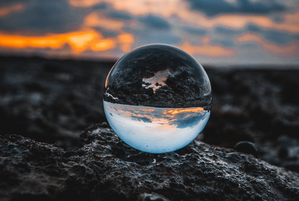 Glass orb sunset earth inverted original Photo by Louis Maniquet on Unsplash