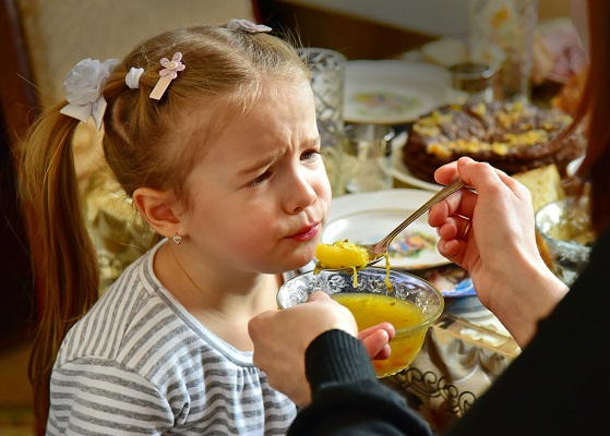 child spoon feeding sourpuss Photo by Михаил Казаченко Pexels