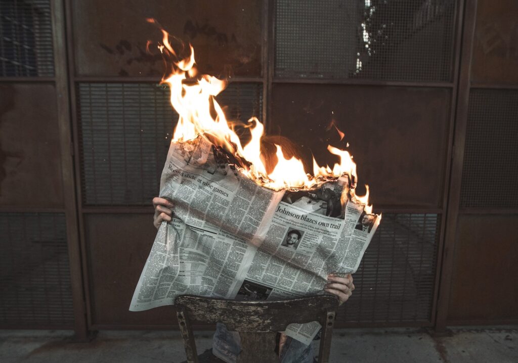 news newspaper fire original Photo by Jeremy Bishop on Unsplash