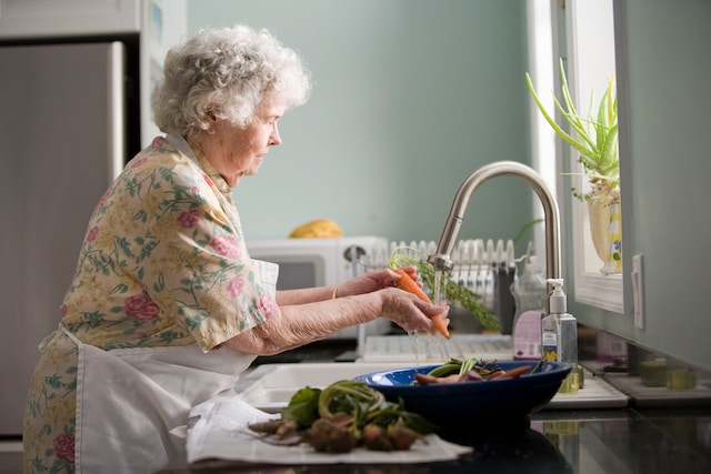 Senior Citizen washing vegetables